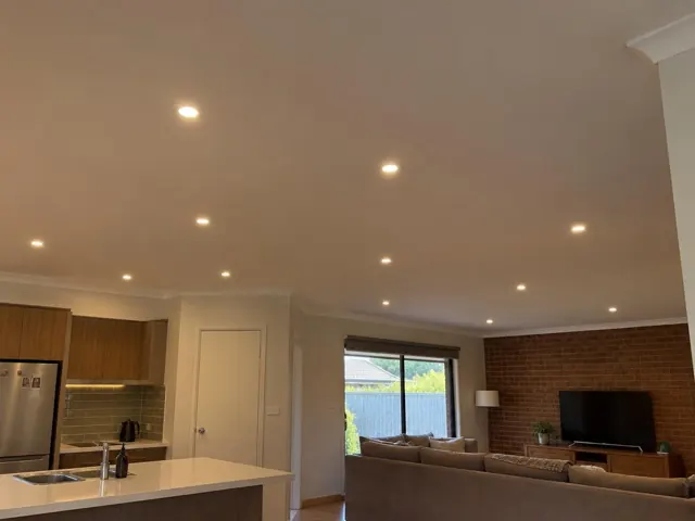 Ceiling with evenly spaced recessed downlights over an open-plan kitchen and living room in Wadalba